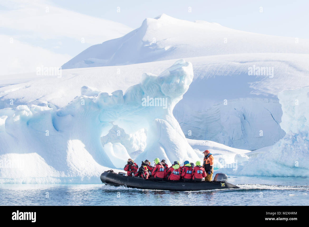 A group of tourists on a zodiac cruise amongst the icebergs of Whilemina Bay, Antarctica. Stock Photo