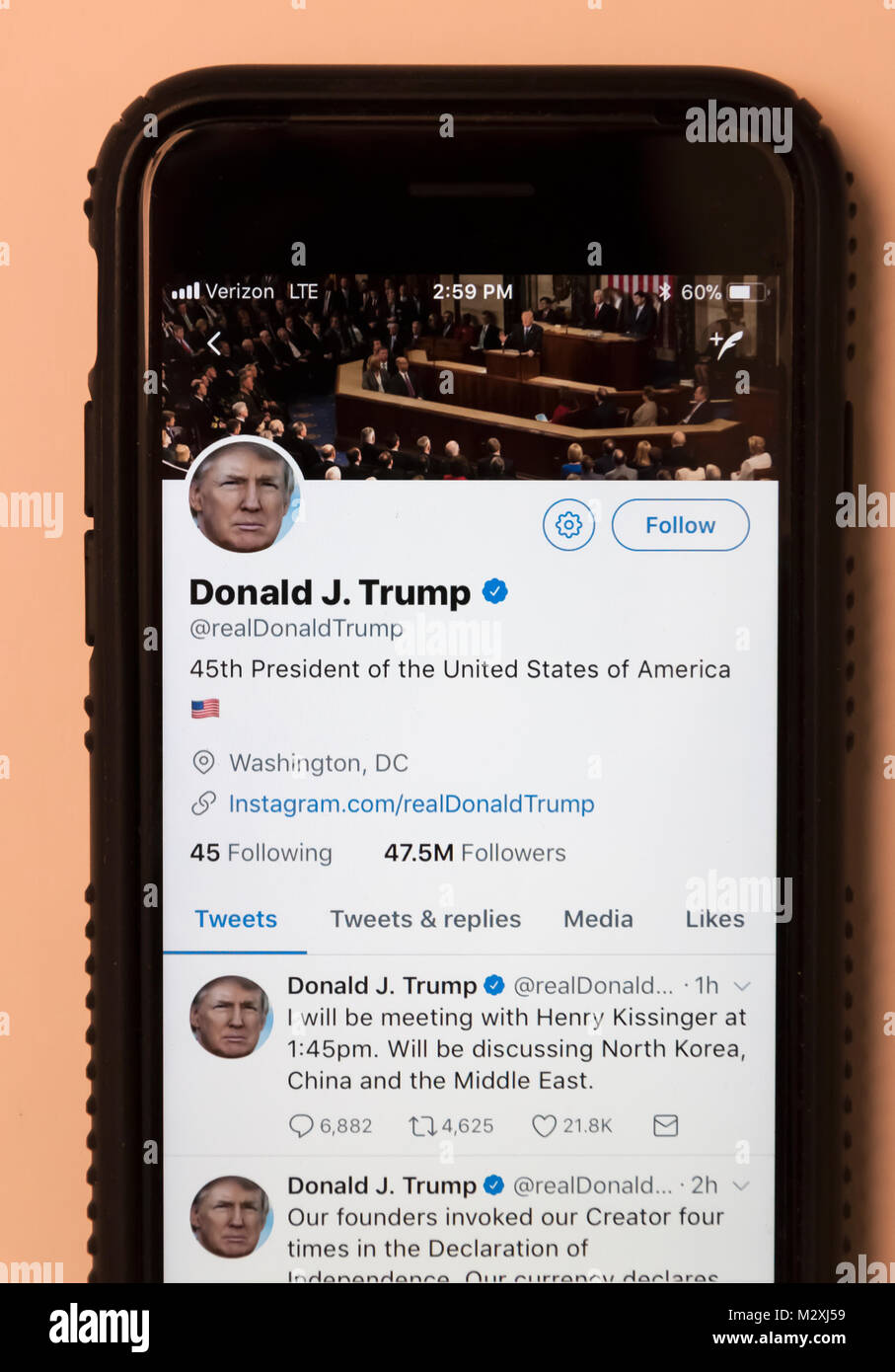 President Donald Trump's Twitter page as seen on a cellphone. Stock Photo