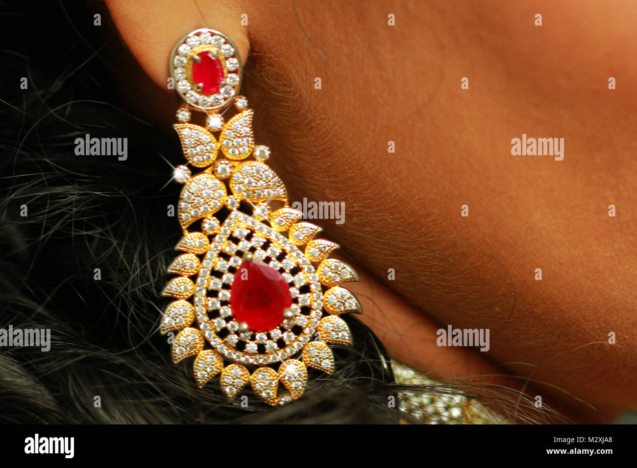 Indian woman wearing gold earrings hi-res stock photography and images ...