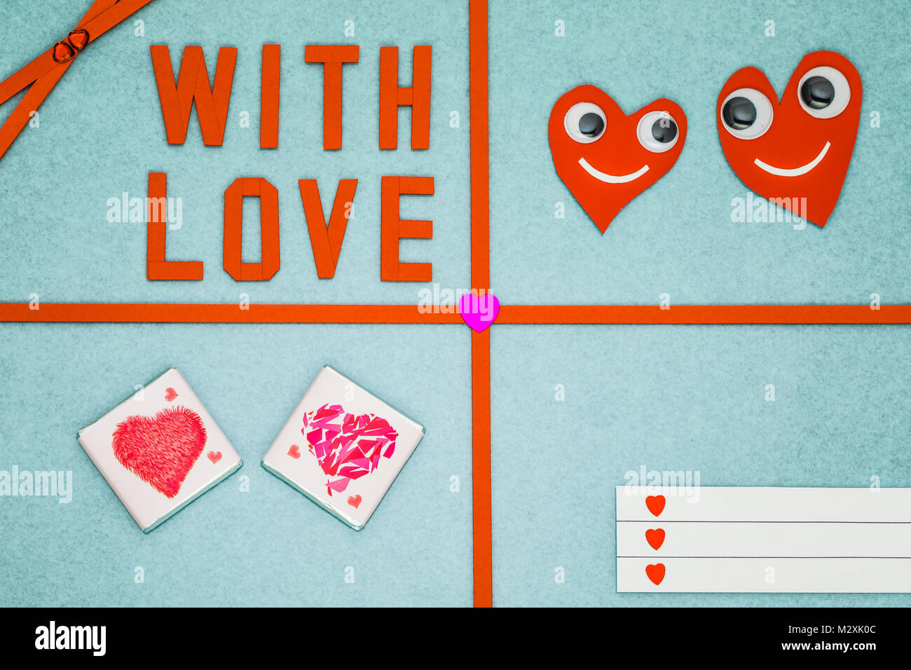Greeting card 'Hearts with eyes + With Love' on colored background Stock Photo