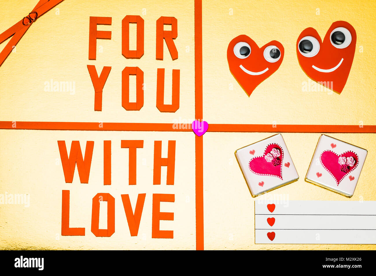 Greeting card 'Hearts with eyes + For You with love' on colored background Stock Photo