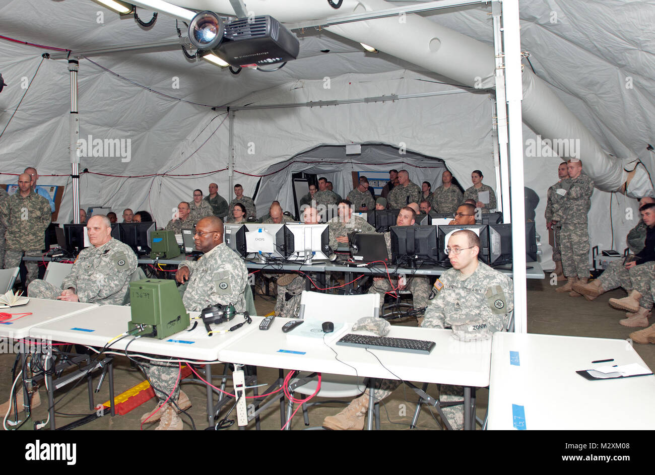 Soldiers of the 316th ESC prepare to start a staff integration training scenario at a SICUPS site at Fort Dix, N.J., March 27.  This exercise is a combination of lessons learned during annual training that will give Soldiers the chance to experience how fast passed and stressful real situations can be.  (U.S. Army Photo by Army Sgt. Peter J. Berardi, 316th Sustainment Command (Expeditionary)) 20120327-A-JW784-011 by 316th ESC Stock Photo