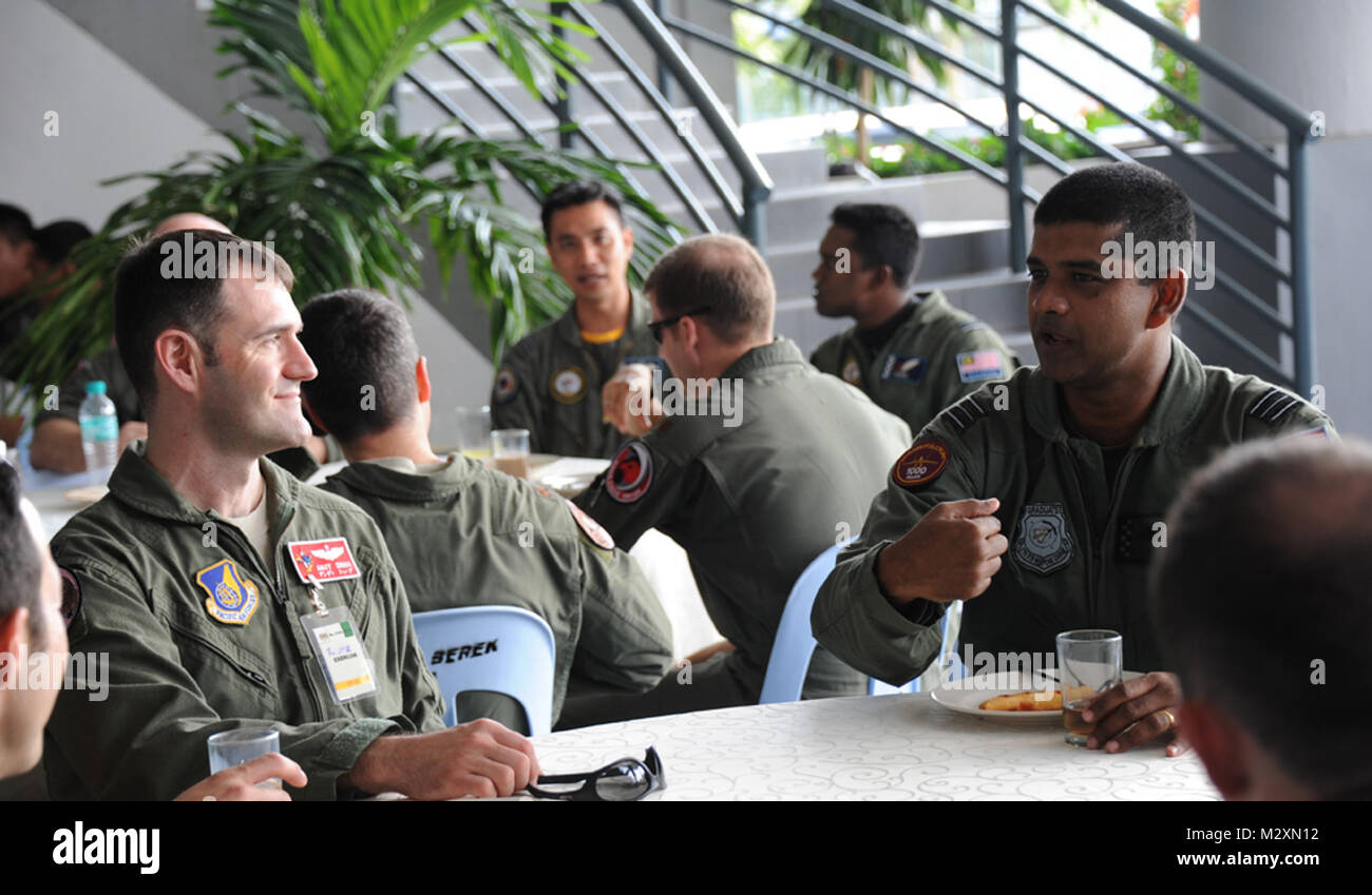 Royal Malaysian Air Force Maj. Sebastian William (right), MiG 29N Fulcrum pilot, talks with Lt. Col. Andy Shobe, 67th Fighter Squadron detachment commander, following the opening ceremony of Cope Taufan 2012 at TUDM Butterworth Apr. 4, 2012. Cope Taufan, the biennial live-flying exercise between the U.S. Air Force and RMAF, includes dissimilar basic fighter maneuvers and dissimilar air combat tactics training.  (U.S. Air Force photo/Master Sgt. Matt Summers/released) Cope Taufan, the biennial live-flying exercise between the U.S. Air Force and RMAF by #PACOM Stock Photo