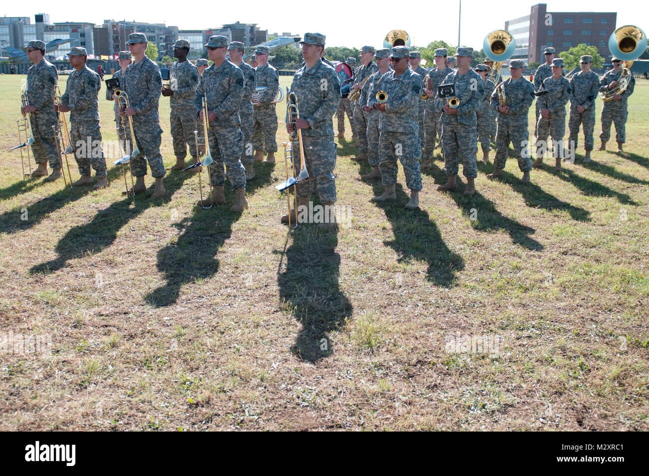 The 36th Infantry Division Band stands in silence before the opening