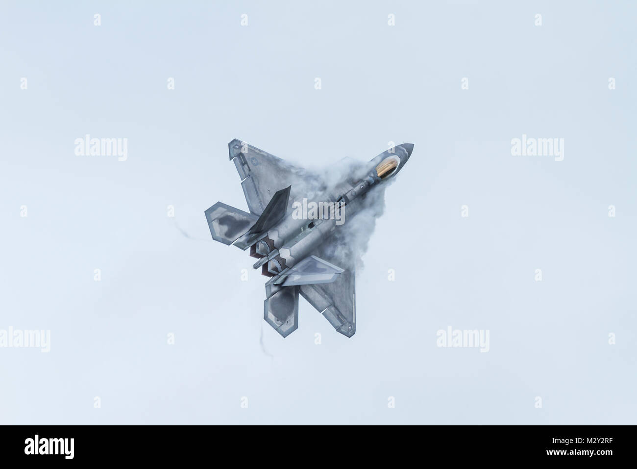 A Lockheed Martin F-22 Raptor from the United States Air Force in a climbing turn with vortices on July 9th 2016 at Duxford, Cambridgeshire, UK Stock Photo