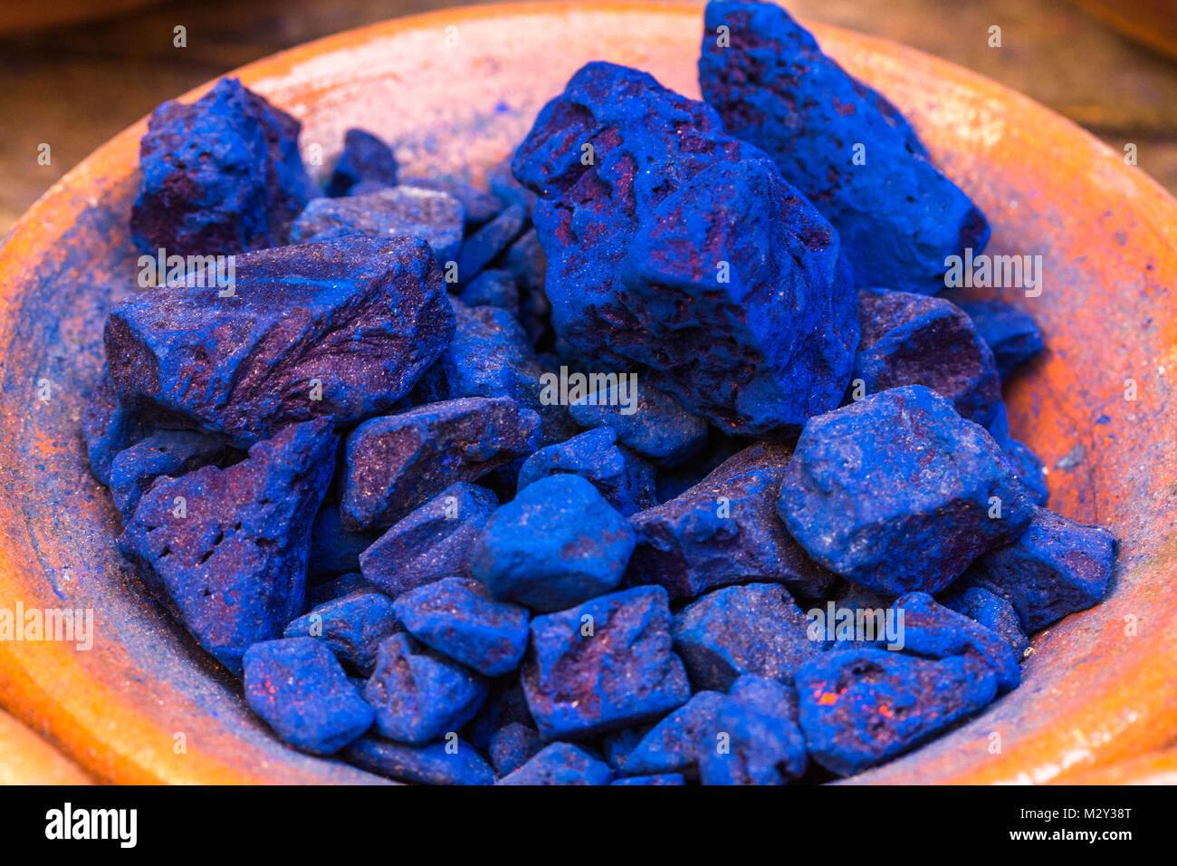 Colourful pigment powders in clay pots used for wool painting