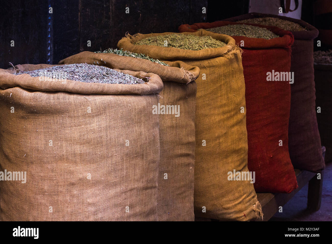 Row of hessian sacks of herbs and spices for sale in the markets souks of Marrakesh, Morocco. Stock Photo