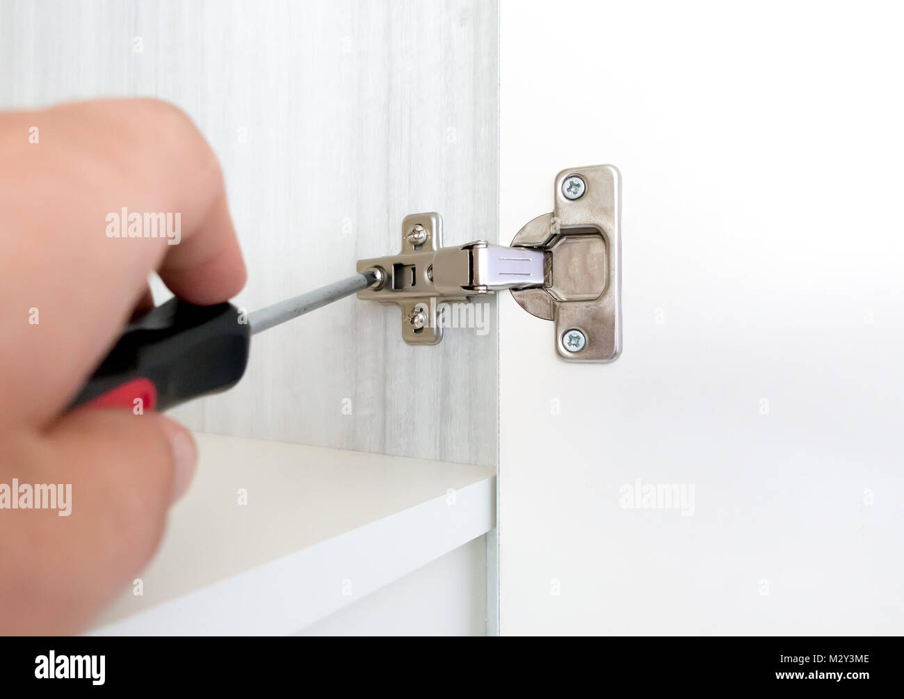 Repairman Install Cabinet Hinge Stock Photo Alamy
