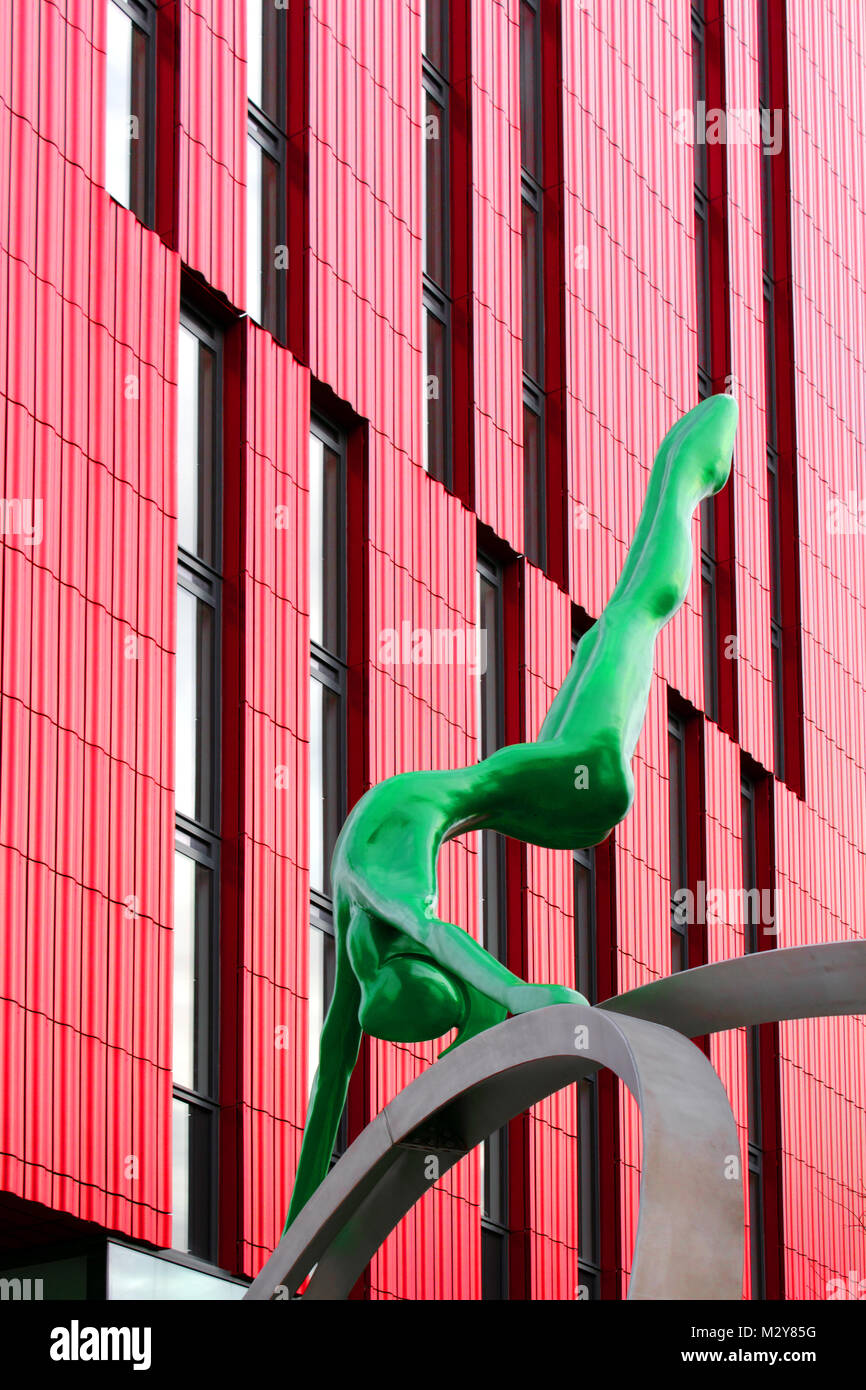 Upright view of green figure with red Innside Hotel as backdrop Stock Photo