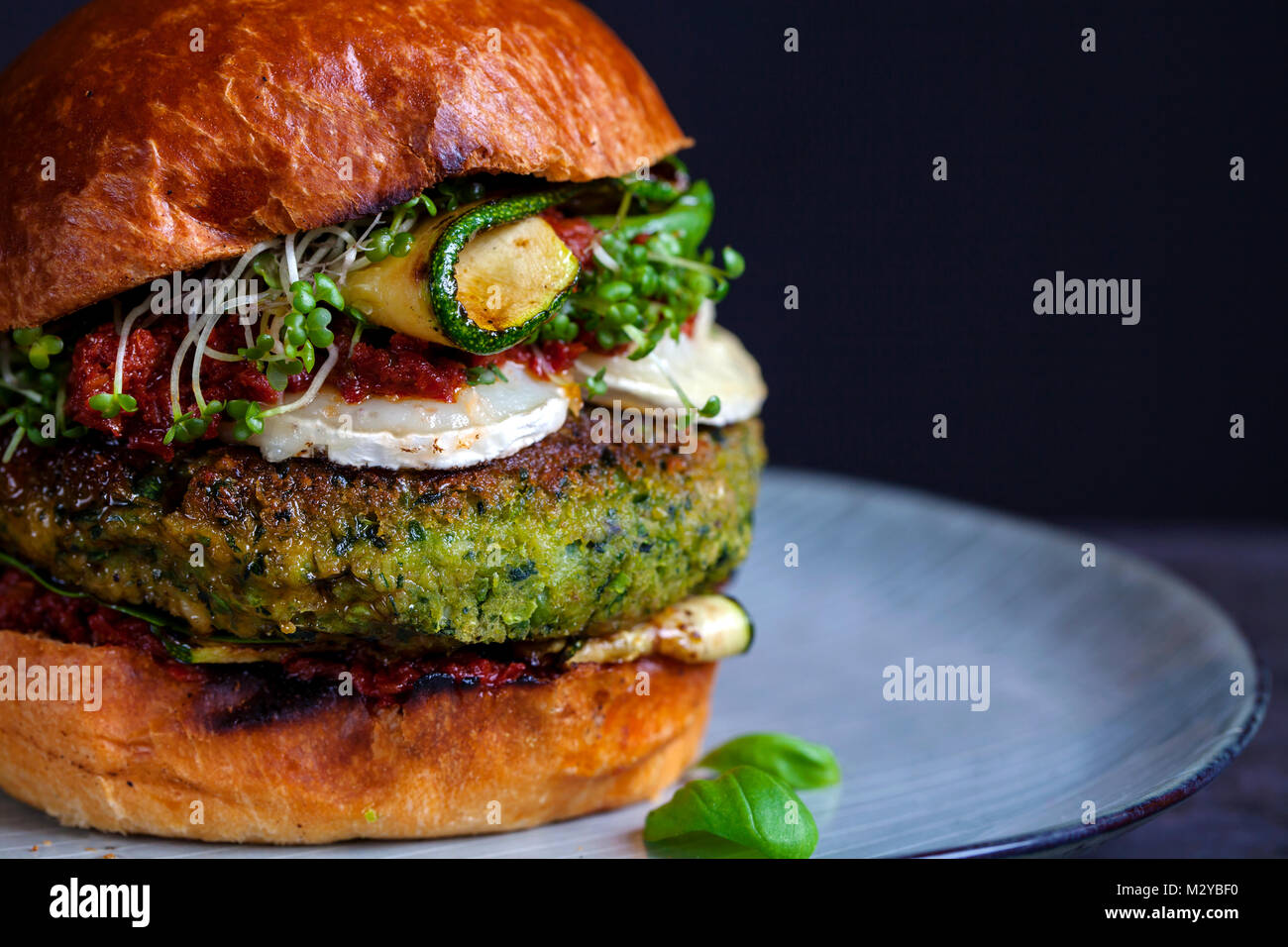 Vegetarian burger made of green pea, butter beans and spinach with sundried tomato pesto and