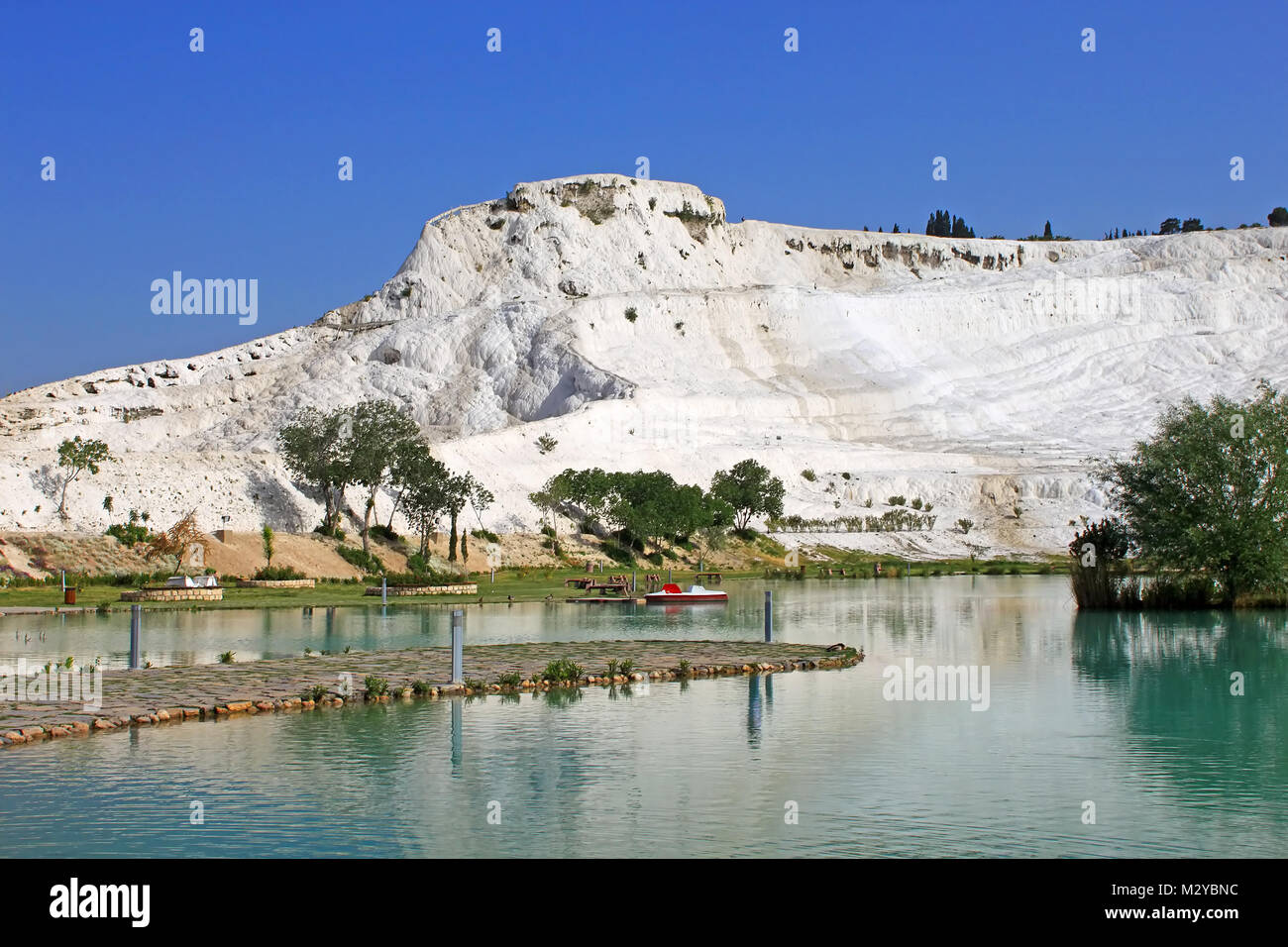 Lake and calcified limestone terraces on background, Pamukkale, Turkey Stock Photo