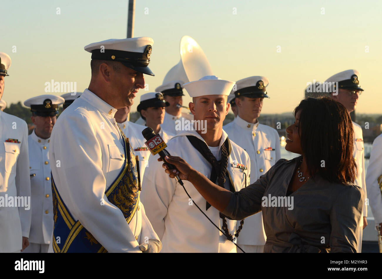 120615-N-HG258-097 BALTIMORE, MD (June 15, 2012) Senior Chief Musician Mike Bayes, left, assistant drum major with the U.S. Navy Ceremonial Band discusses the Navy Band's involvement in Sailabration 200 prior to a live broadcast aboard USS San Antonio (LPD 17) on Baltimore's WJZ Morning News. The Navy week is part of Baltimore's Star Spangled Sailabration and commemorates the bicentennial of the War of 1812 and the writing of the Star Spangled Banner. (U.S. Navy Photo by Chief Musician Stephen Hassay/Released) 120615-N-HG258-097 by United States Navy Band Stock Photo