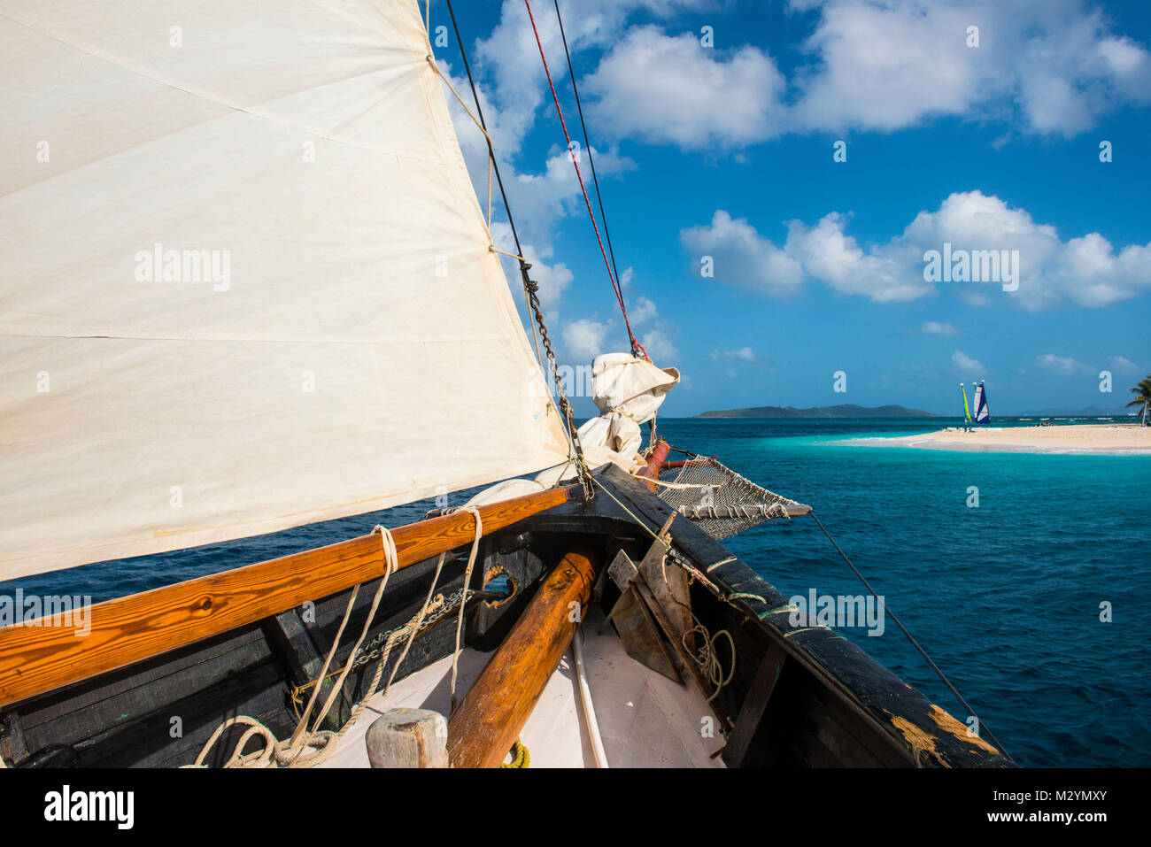 Sailing boat and  a white sand beach on Palm island, Grenadines islands, St. Vincent and the Grenadines, Caribbean Stock Photo