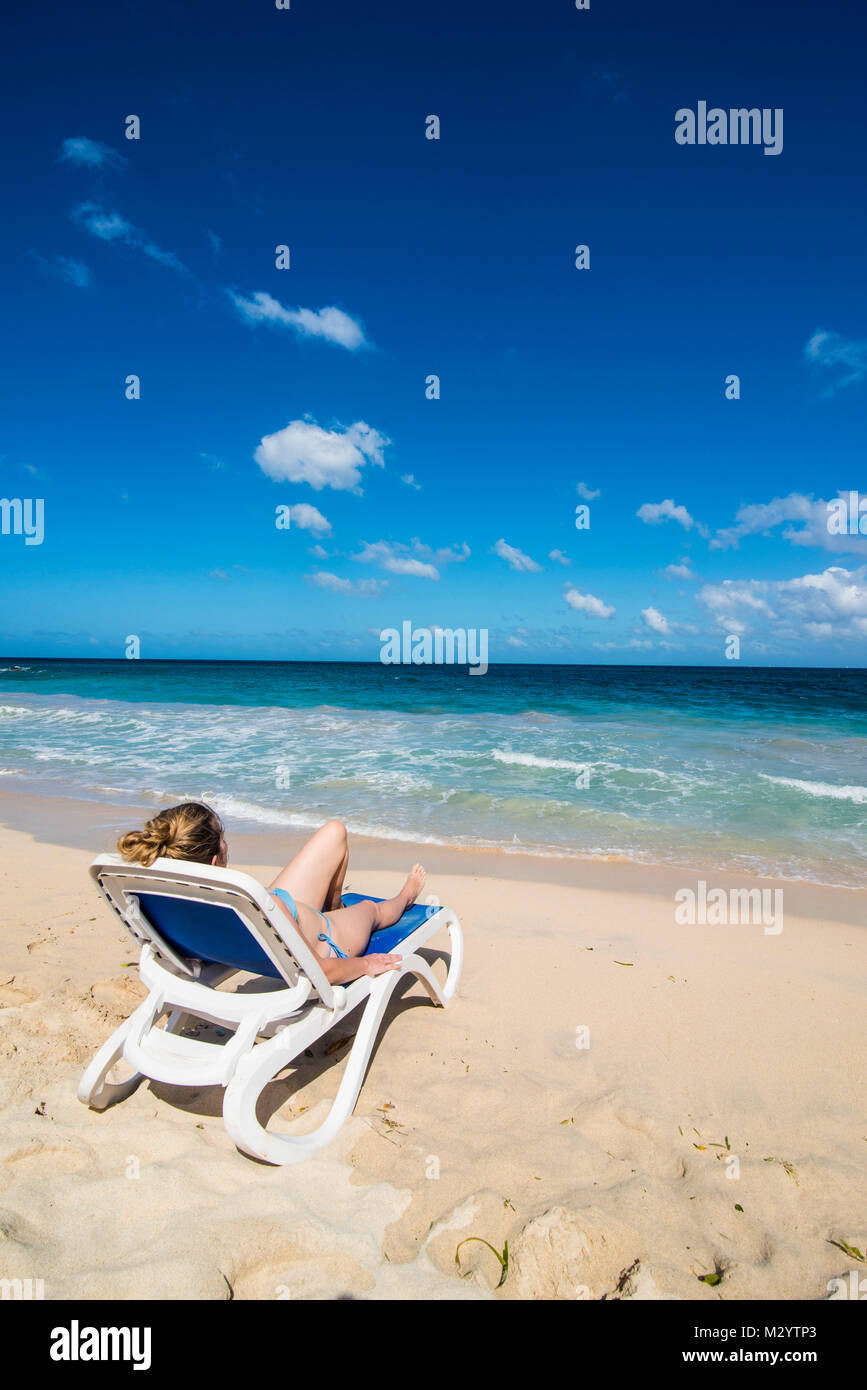 Woman relaxing on the beach of Grande Anse, Grenada, Caribbean Stock Photo
