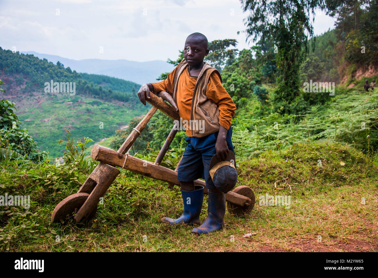 Young boy with his self made bicycle made purely out of wood, southern Uganda, Africa Stock Photo