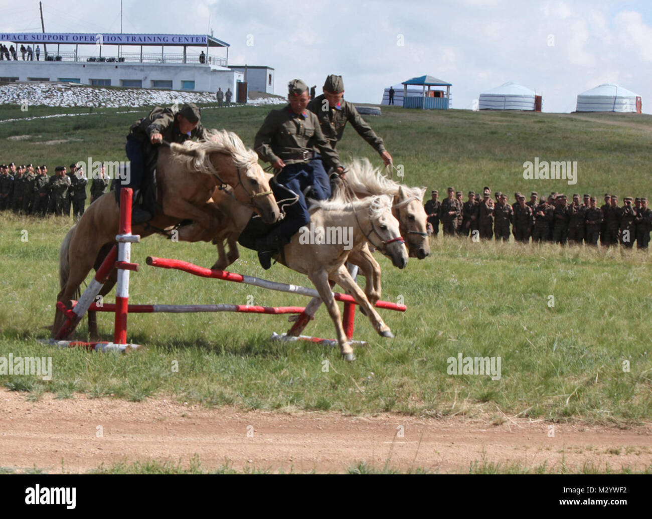 REGIONAL PEACE SUPPORT OPERATIONS TRAINING CENTER, FIVE HILLS TRAINING AREA, MONGOLIA- Members of the Mongolian Armed Forces present a cavalry demonstration for the participants of Exercise Khaan Quest 2012 at the Regional Peace Support Operations Training Center at the Five Hills Training Area near Ulaanbaatar, Mongolia Aug. 12. The history of Mongolian cavalry dates back to the days of Ghengis Khaan. (U.S. Marine Corps photo by Lance Cpl. Matthew Manning/Released) Khaan Quest 2012 by #PACOM Stock Photo
