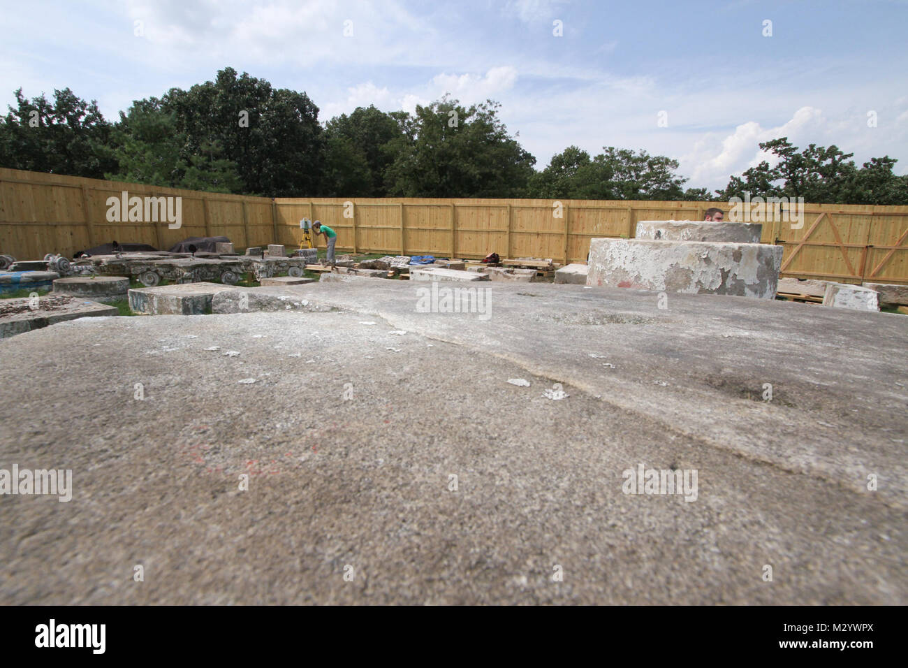 ARLINGTON, Va. – Paul Davidson, an architect with the National Park Services’ Historic American Building Survey team, sets up a 3D laser scanner to gather detailed electronic measurements on pieces of sandstone columns that once stood at the War Department, August 14, 2012. The columns were moved to Arlington National Cemetery in 1879 and repurposed as gates at the cemetery until 1971 when the cemetery was expanded and the gates were deemed not large enough to allow vehicle traffic through. The gates have been in storage at the cemetery ever since. The cemetery is working with the U.S. Army Co Stock Photo