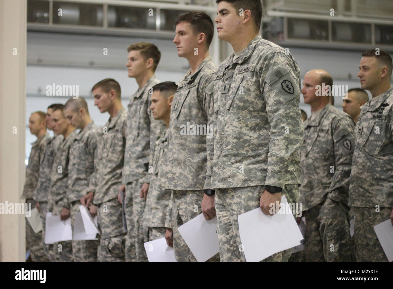 Pathfinder school graduates stand in formation during the graduation