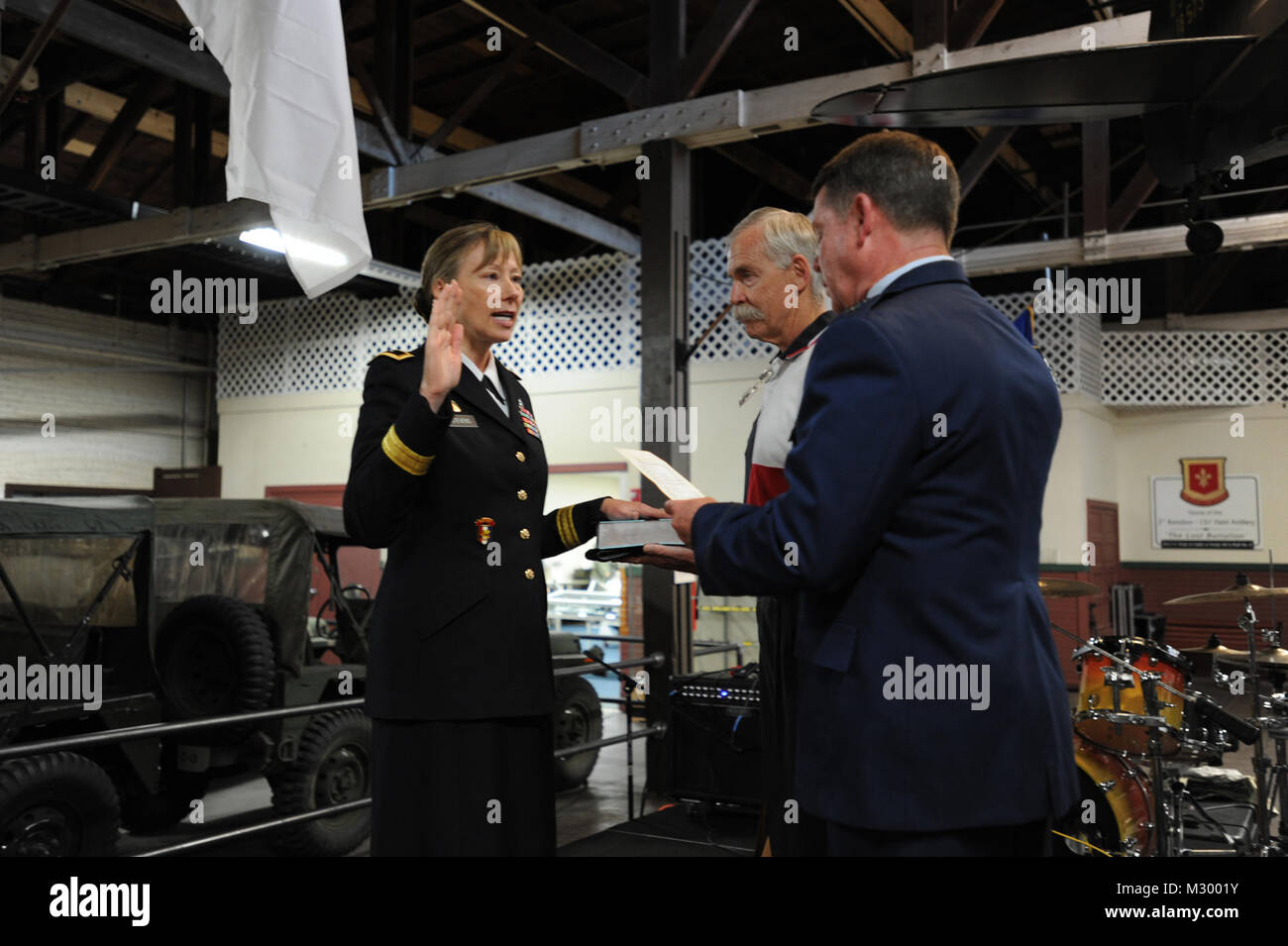 Maj. Gen. John F. Nichols swears in Maj. Gen. Joyce L. Stevens, Assistant Adjutant General-Army for the state of Texas, during her promotion ceremony at Camp Mabry in Austin, Texas on Sep. 5, 2012, as her husband, Col. (Ret.) Stryker looks on. Maj. Gen. Joyce L. Stevens Promotion- Swearing In by Texas Military Department Stock Photo