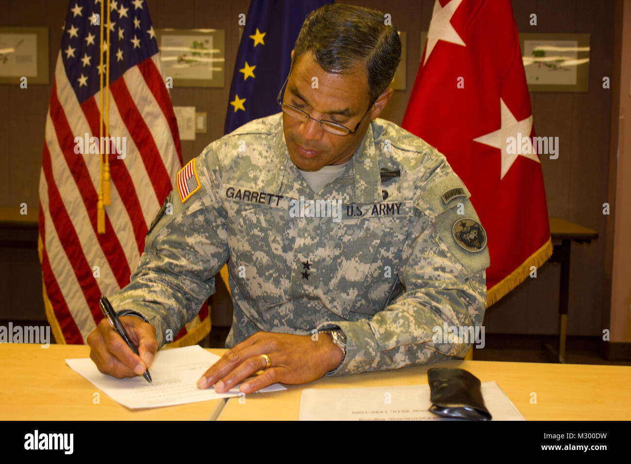 Maj. Gen. Michael Garrett, commander of U.S. Army Alaska, signs a memorandum of Acknowledgement for the establishment of the School Partnership Program during a meeting at the Fairbanks North Star Burough school District building in Fairbanks, Alaska Sept. 10. The program which was initiated by former USARAK Commander Lt. Gen. William Troy, brings together the local Fairbanks Community with the various Army units throughout Alaska in an effort to help strengthen an already strong relationship. (U.S. Army Photo By: Sgt. Thomas Duval, 1/25 SBCT Public Affairs) 120910-A-BE343-009 by 1 Stryker Bri Stock Photo