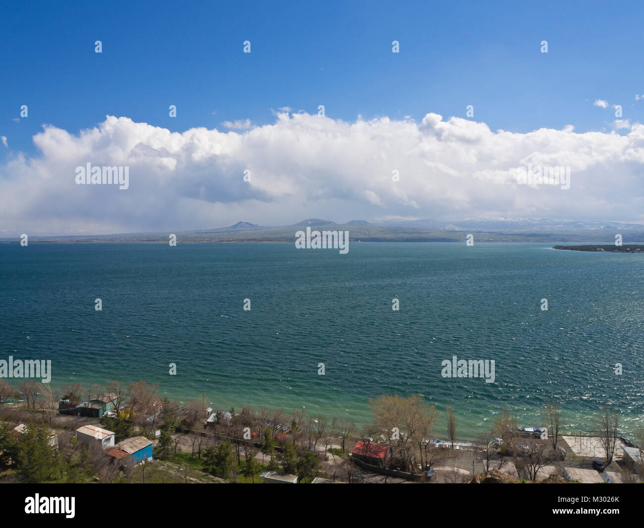 Lake Sevan in Armenia at an altitude of altitude of 1,900 m, the largest fresh water reserve in the area, panorama view, shoreline, trees and cabins Stock Photo