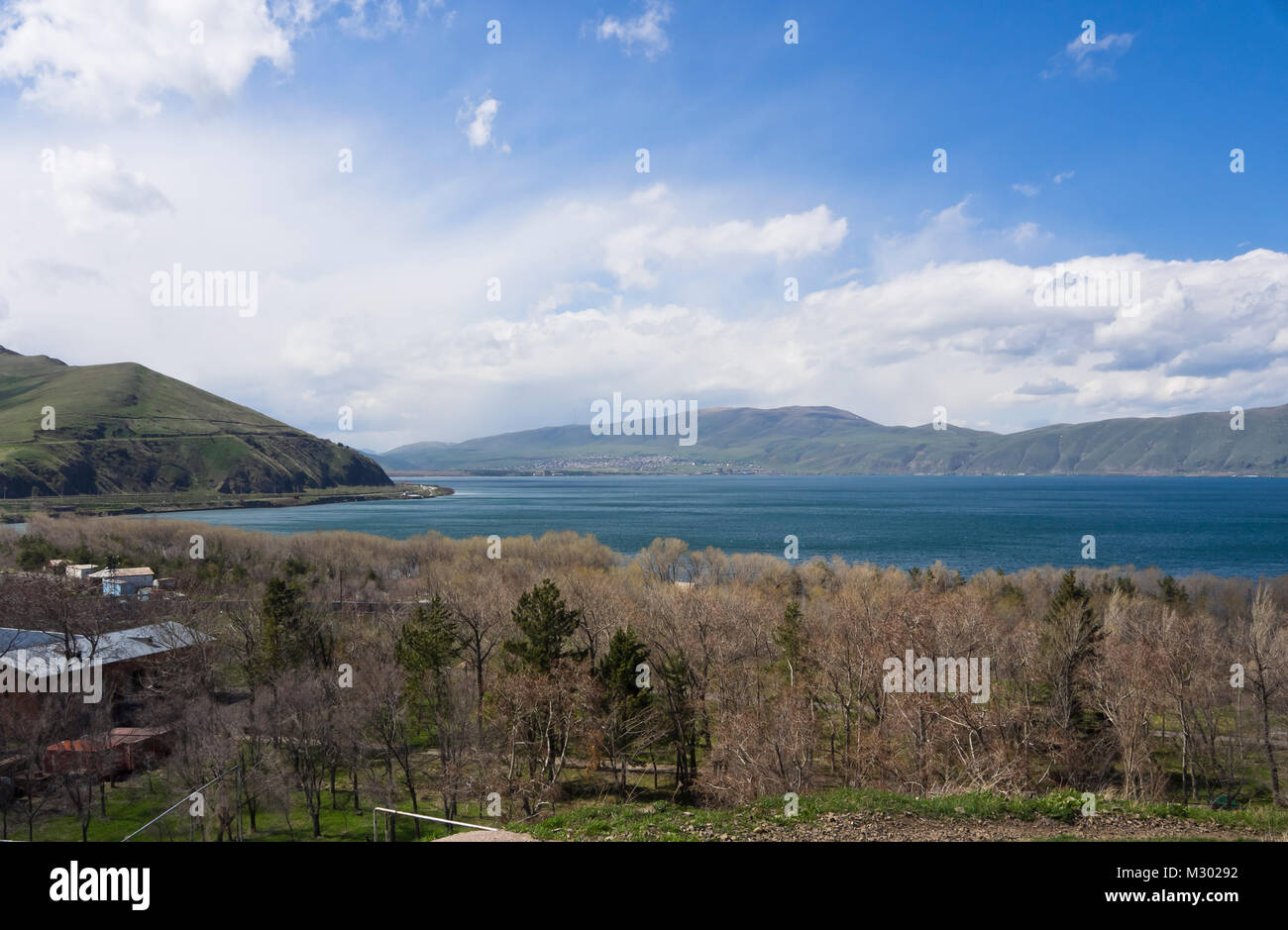 Lake Sevan in Armenia at an altitude of altitude of 1,900 m, the largest fresh water reserve in the area, panorama view, shoreline, trees and hills Stock Photo