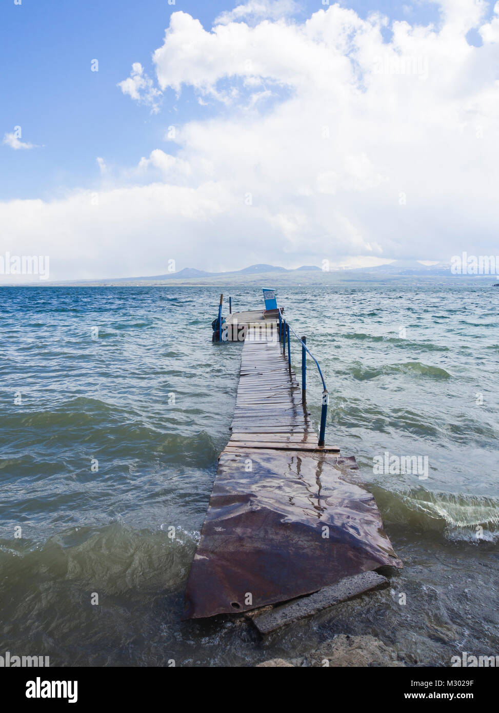 Lake Sevan in Armenia at an altitude of altitude of 1,900 m, the largest fresh water reserve in the area, ripples and old pier for swimmers Stock Photo