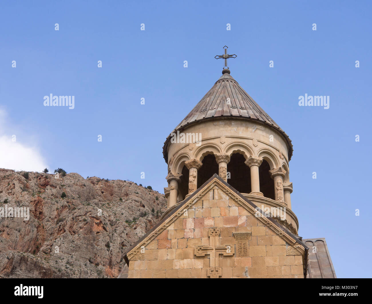 Noravank Monastery in southern Armenia, facade detail of the Surb Astvatsatsin Church with red cliff walls and blue sky Stock Photo