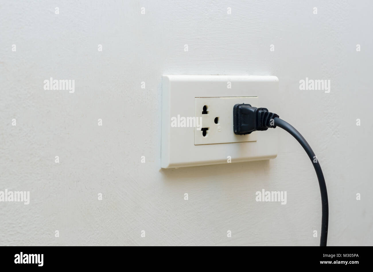 hand outlet Power saving Hand inserting electrical plug into outlet Stock Photo