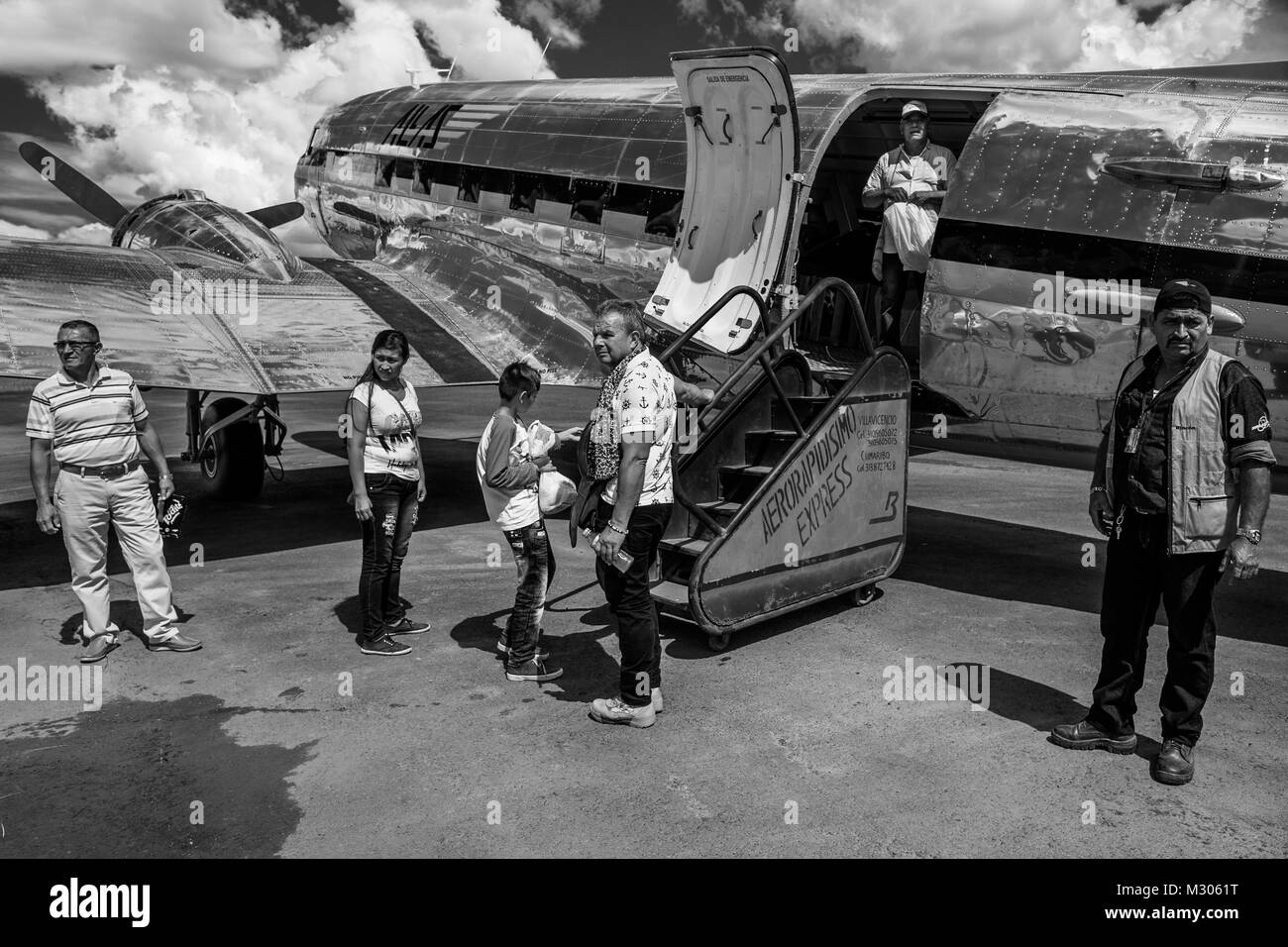 Passengers board a Douglas DC-3 aircraft at the runway of the airport in Barranco Minas, Colombia. Stock Photo