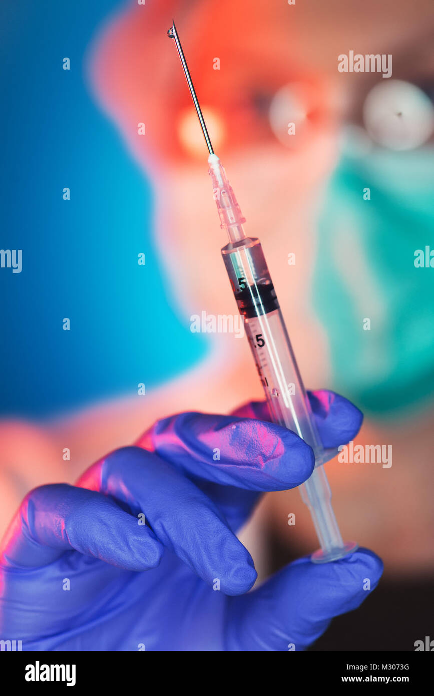Vaccination is important for immunization. Female medical professional with vaccine syringe Stock Photo