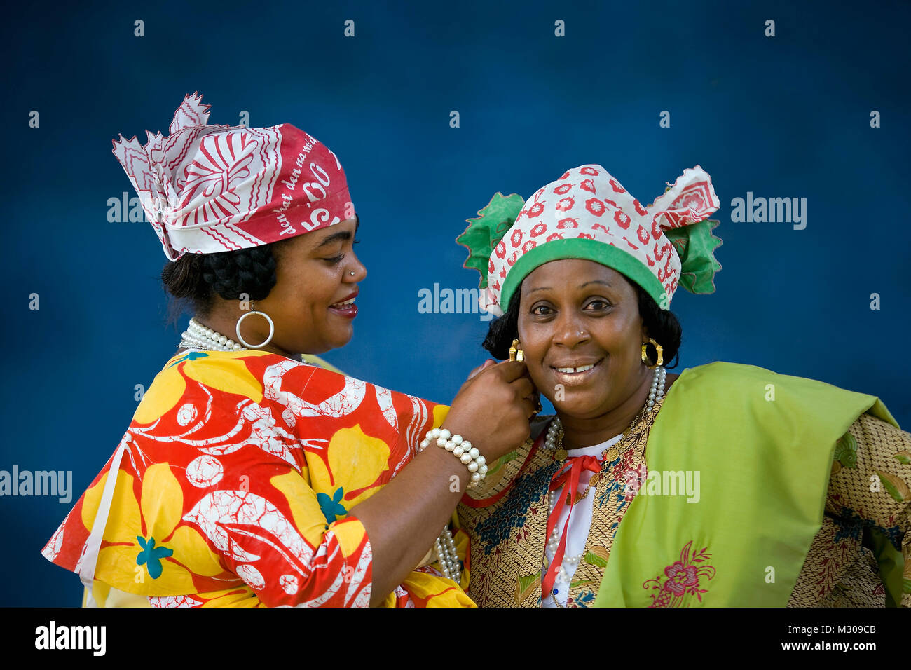 Suriname, Paramaribo. Creole women in Kotomisi dress,  the national creole costume. Stock Photo