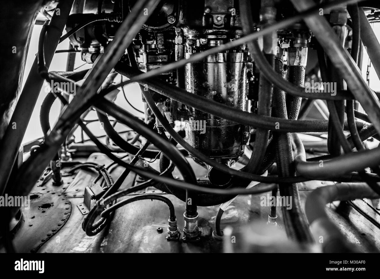 Fuel pipes and hydraulic components are seen inside an engine of a Douglas DC-3 aircraft at the airport of Villavicencio, Colombia. Stock Photo