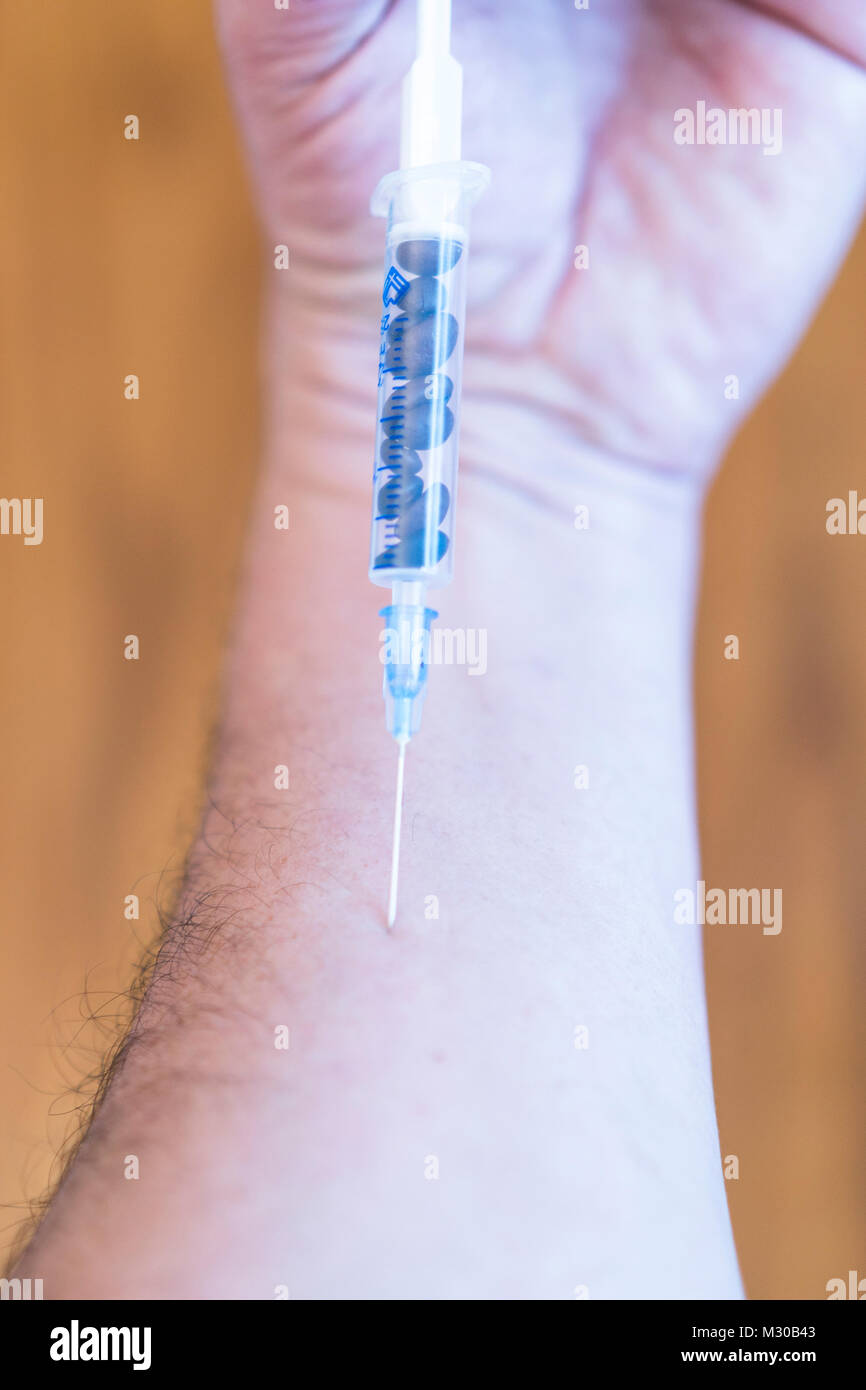 The guy making himself an injection of coffee Stock Photo Alamy