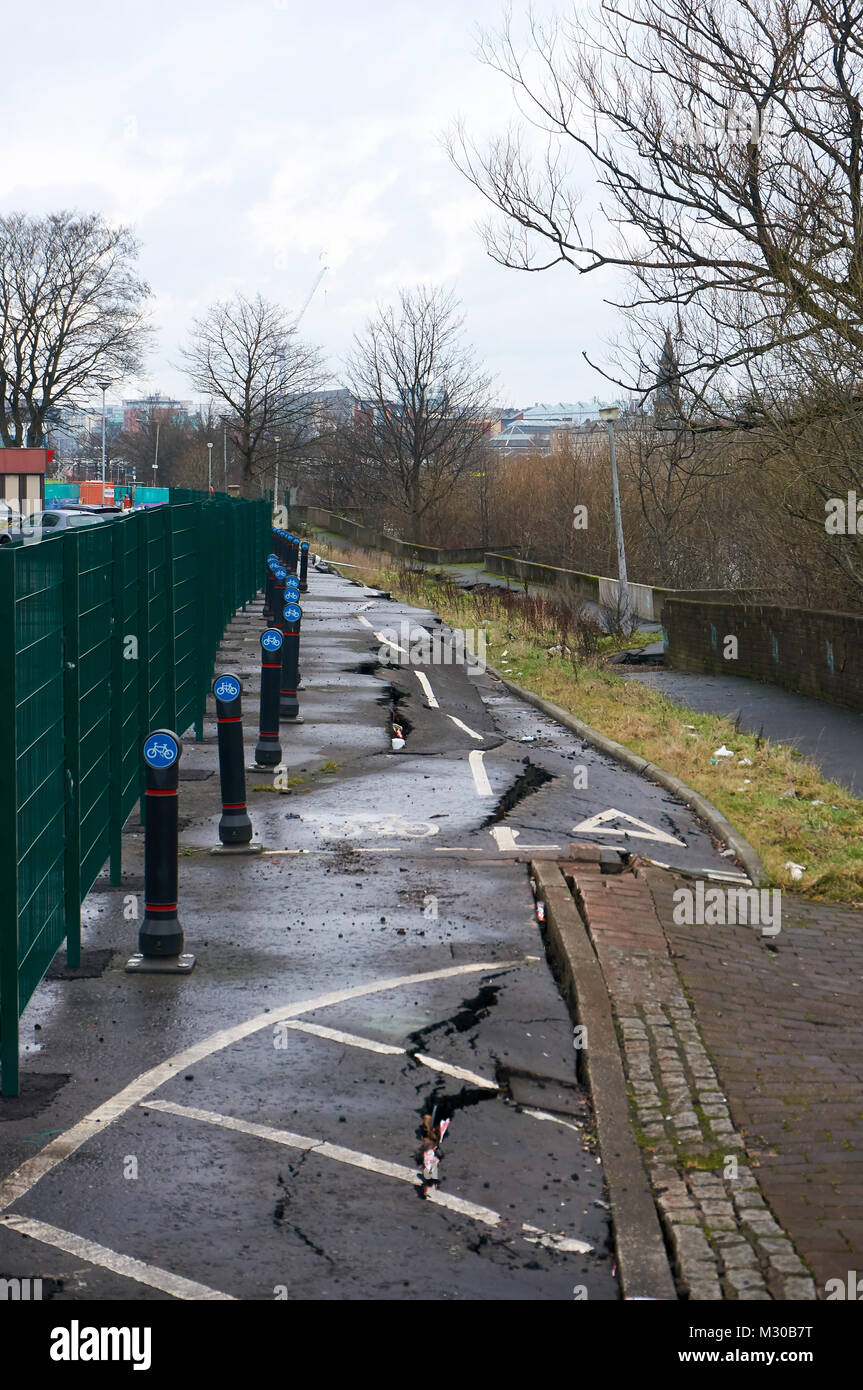 Path on the southern bank of river Clyde damaged due to a collapse of the river bank, as a result of a faulty tidal weir, Glasgow, UK. Stock Photo