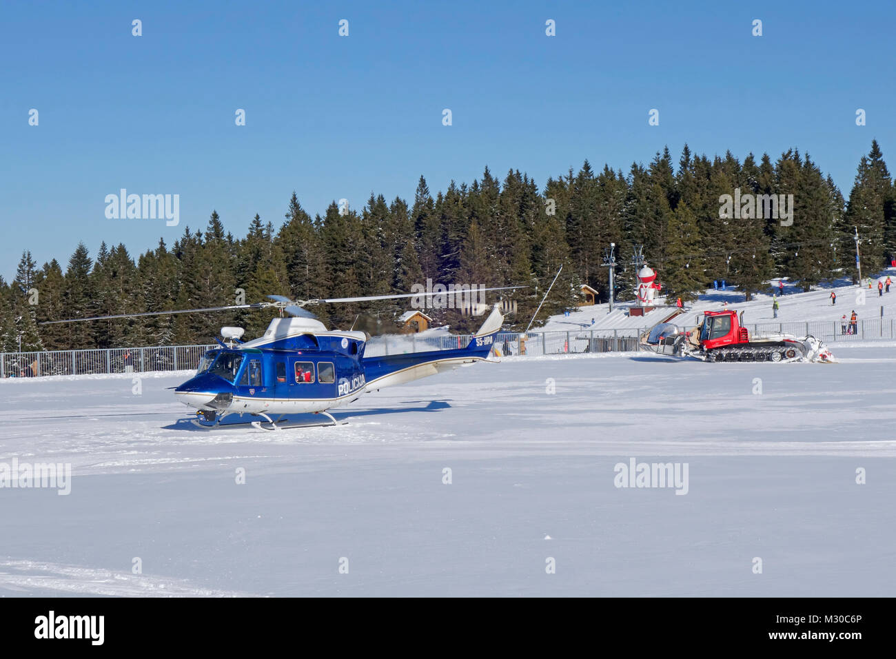 Police helicopter on intervention at Rogla ski resort, Pohorje, Slovenia. Stock Photo