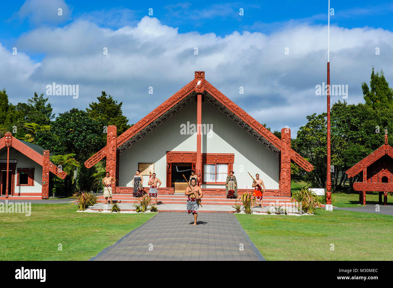 Traditional dressed Maoris in front of the Te Puia Maori Cultural Center, Roturura, North Island, New Zealand Stock Photo