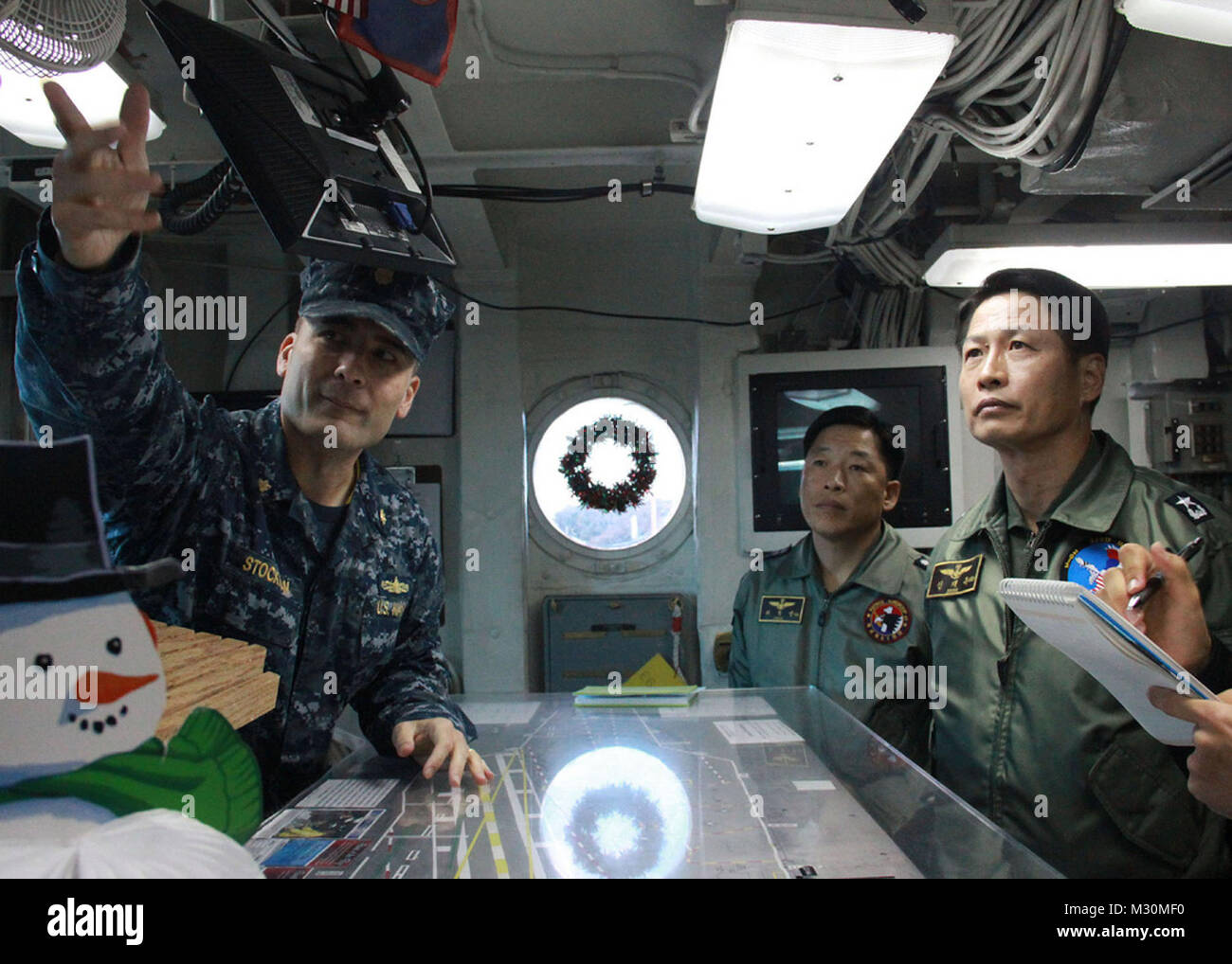 ROK navy Rear Adm. Jae-Ok Shim listens as Lt. Cmdr. James Stockman ...