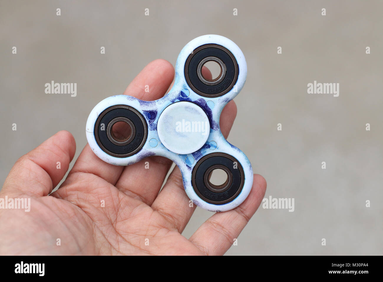 Close up of hand holding fidget spinner Stock Photo Alamy