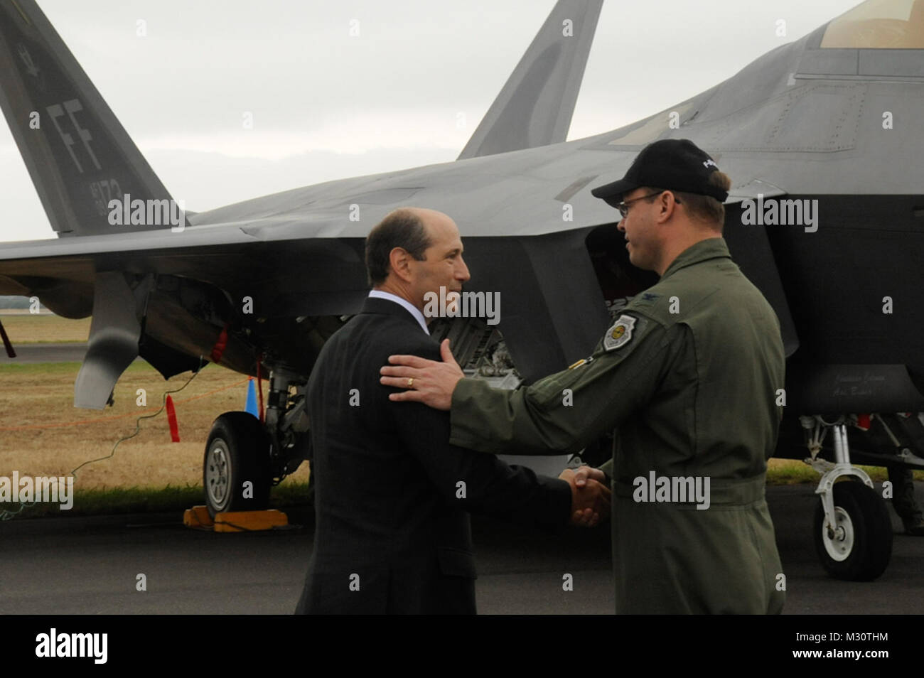 U.S. Air Force Col. Stephen Williams, Misawa Air Base, Japan, wing commander, shakes hands with Jeffrey Bleich, Australian ambassador, as Bleich departs the Australian International Airshow 2013 at Avalon, Australia, Feb. 27, 2013. This marks the second day of the AIA13 at the Avalon Airport. This event features 500 exhibitors from 35 countries and is designed to bolster business opportunities and international aviation sector. U.S. participation in the AIA13 directly supports theater engagements, goals and objectives and further enhances relationships with other Pacific nations. (U.S. Air For Stock Photo