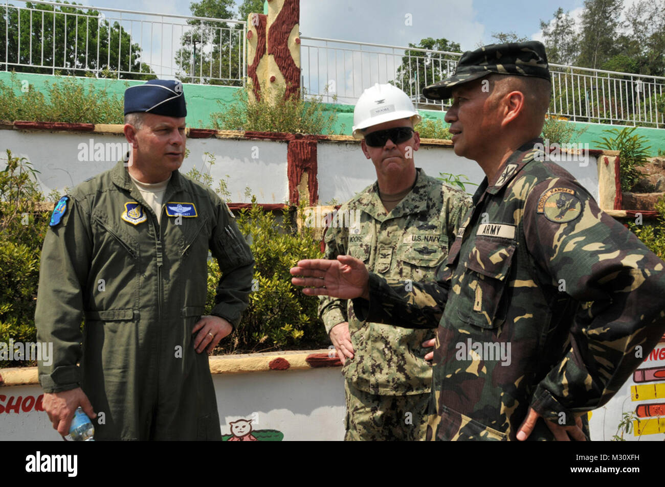 130408-N-FI367-041 ZAMBALES, Philippines – (April 8, 2013) Combined/Joint Civil Military Operations Task Force Commander Philippine Army Col. Arnulfo Pajarillo, right, discusses the progress of the Omaya Elementary School building project with U.S Air Force Brig. Gen. James F. Mackey, Director of Operations, Plans and Policy, PACAF, and U.S. Navy Capt. Rod Moore, Joint Civil Military Operations Task Force Commander, center, during a tour of the project site. Brig. Gen. Mackey visited the site to thank the Philippine and U.S. Airmen for the work they are doing in support of Exercise Balikatan.  Stock Photo