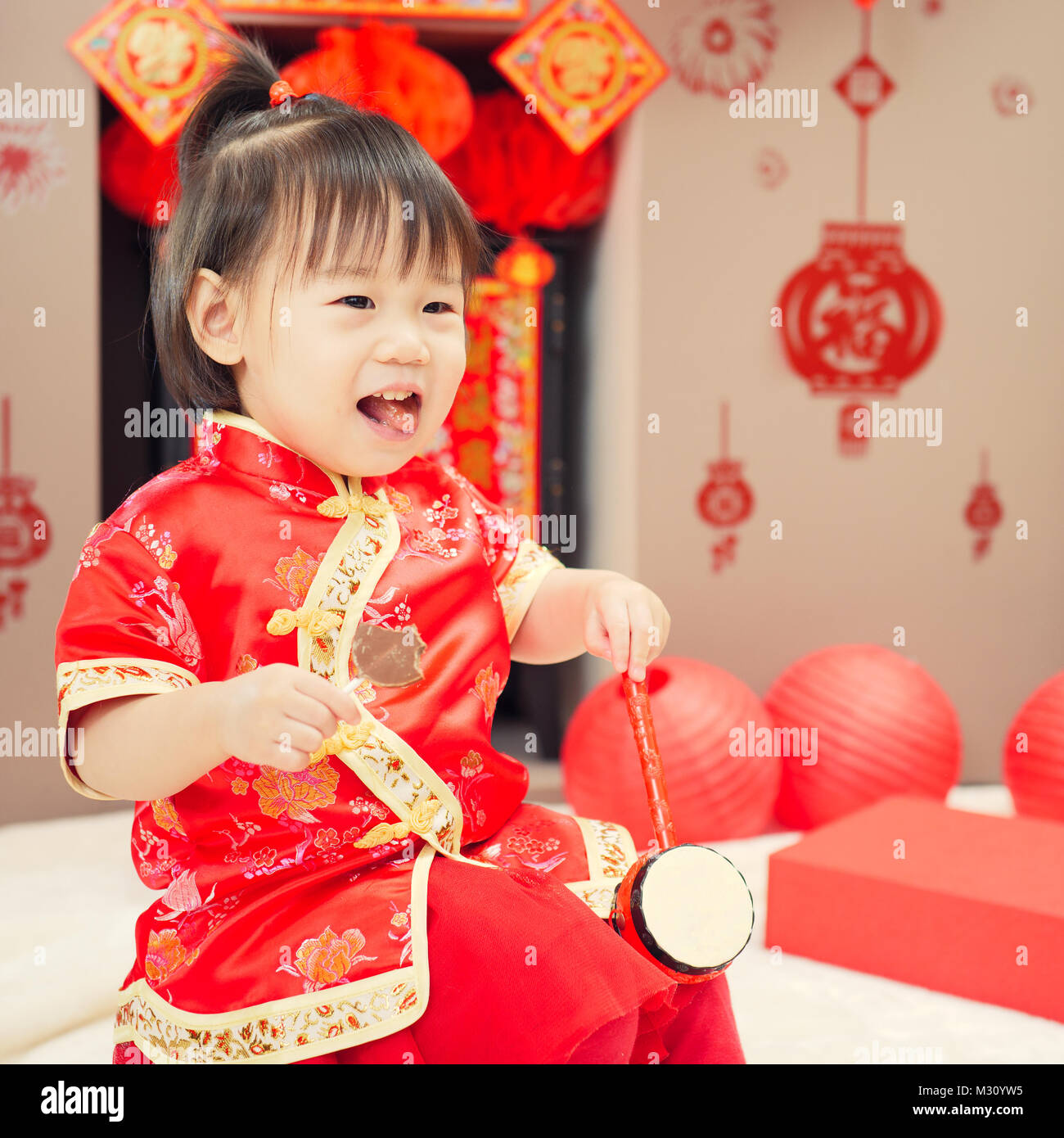 Chinese baby girl with traditional dressing up and "FU" means "lucky