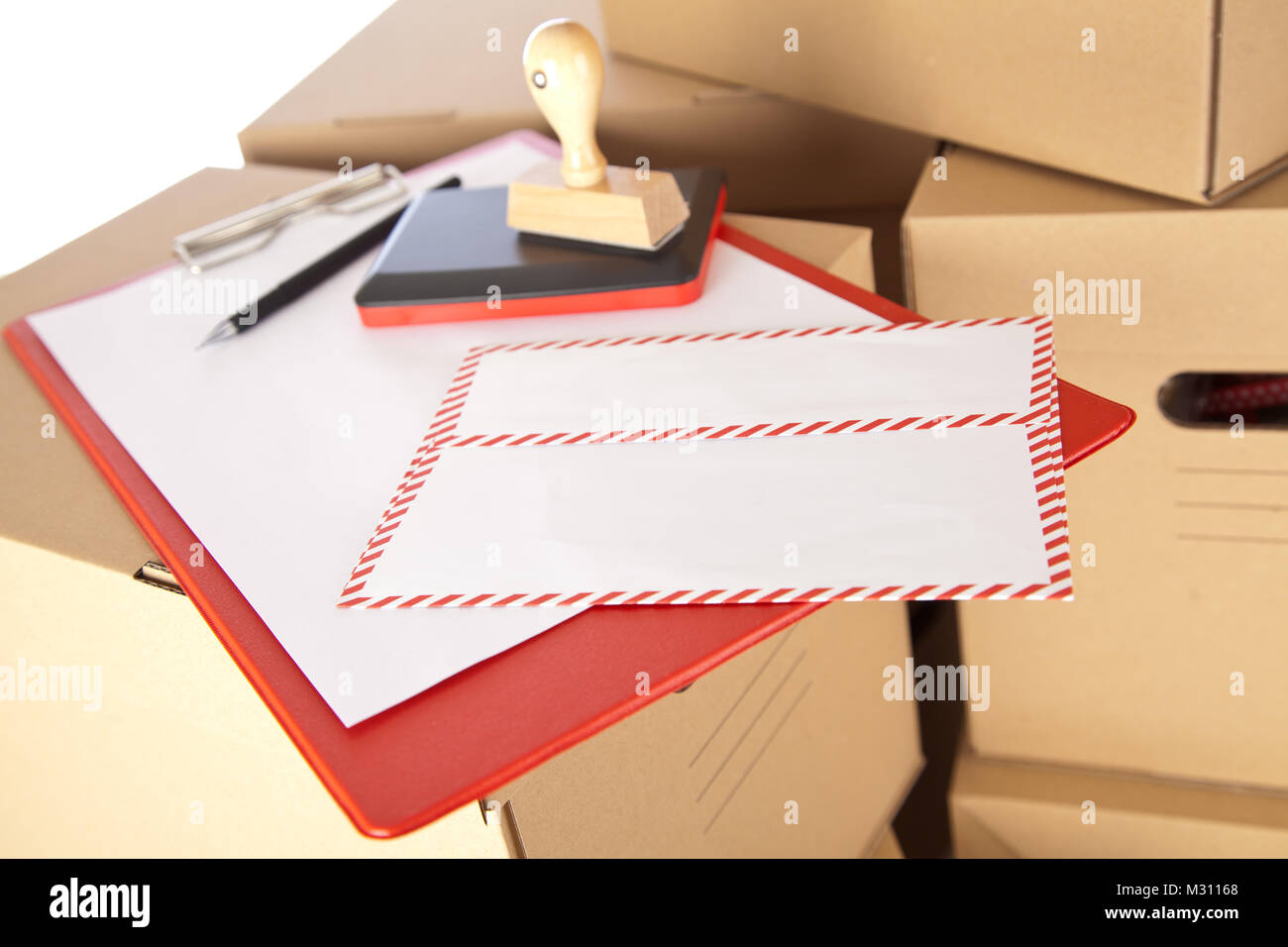 Mail envelope on cardboard boxes Stock Photo