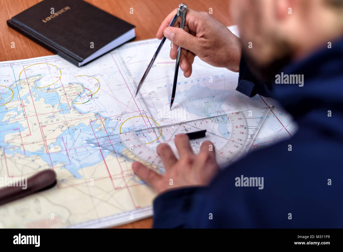 navigation with sea charts in the chart room on a sailing yacht Stock Photo
