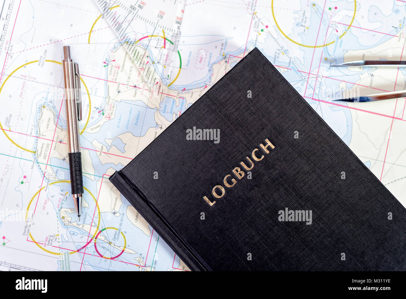 navigation book with sea charts in the chart room on a sailing yacht Stock Photo