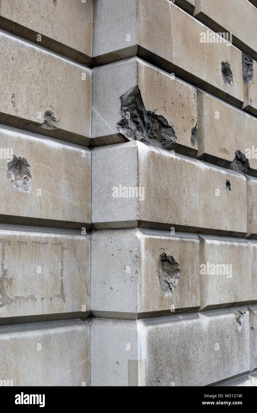 Stone brickwork showing shrapnel damage sustained during World War Two in London, England Stock Photo