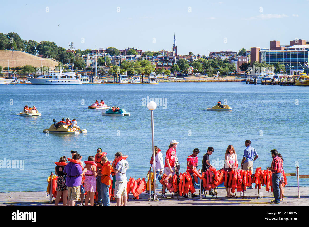 Baltimore Maryland,Inner Harbor,harbour,Patapsco River,port,waterfront,Harborplace,attraction,paddle boat ride,queue,line,Asian Black African Africans Stock Photo