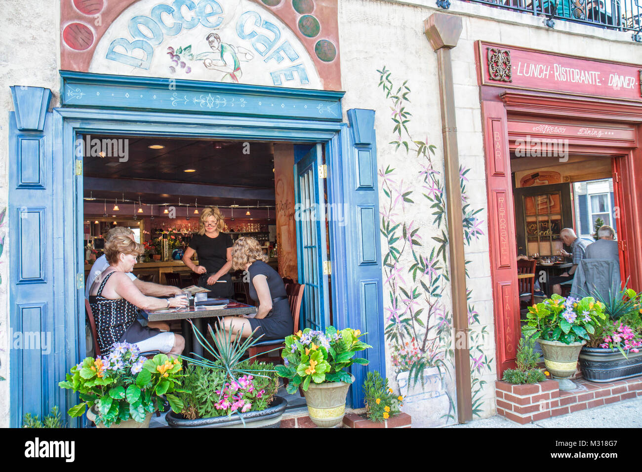 Baltimore Maryland,Little Italy neighborhood,Bocce Cafe,restaurant restaurants food dining cafe cafes,dining,Italian cuisine,window,flower pot,table,m Stock Photo