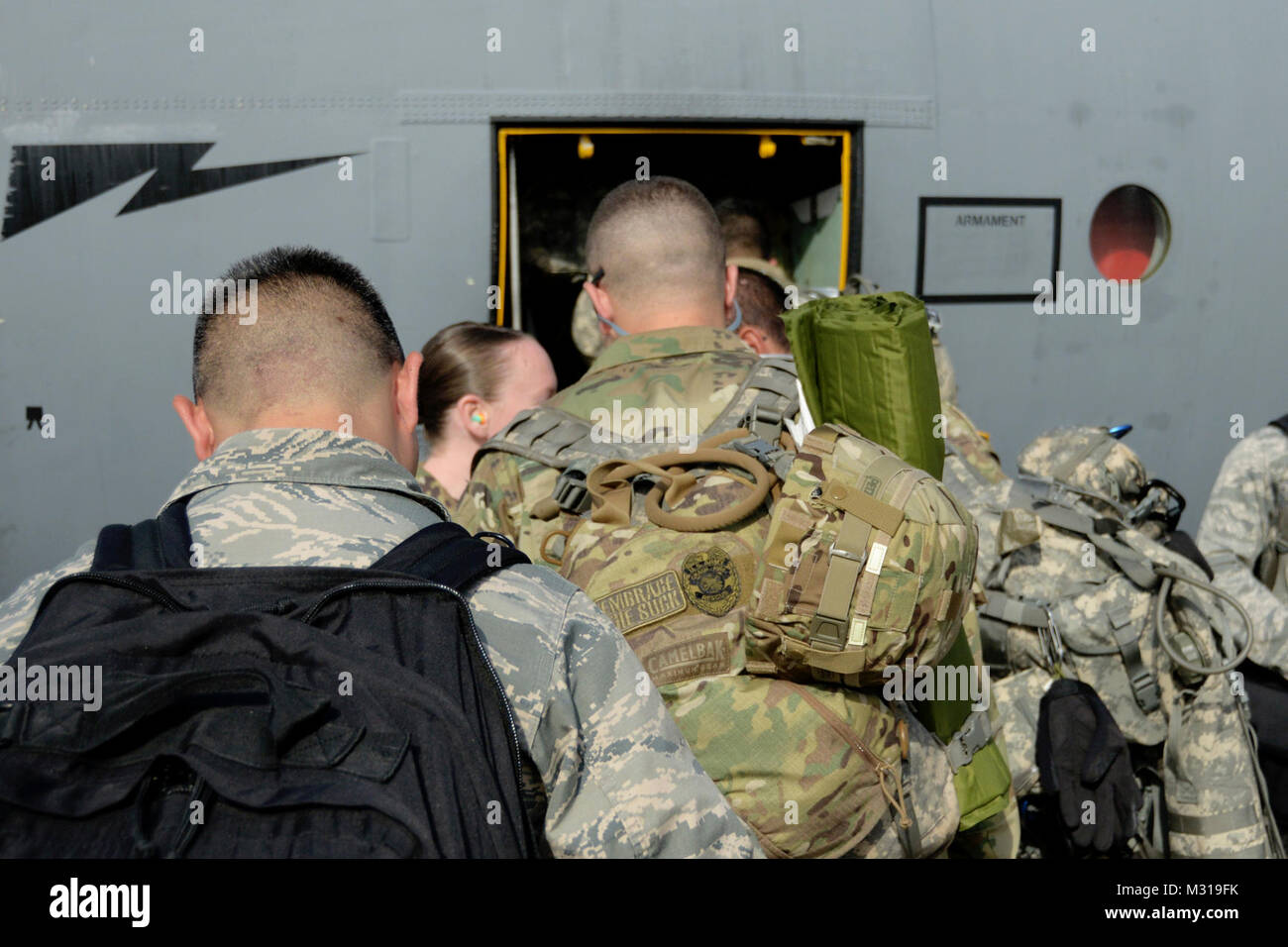 Members of Connecticut Army and Air National Guard board a C130
