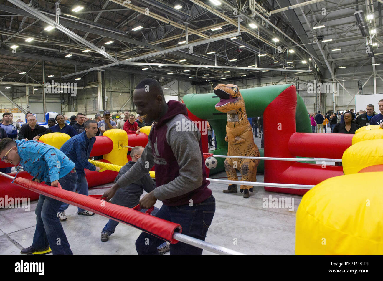 Attendees participate in a humansized inflatable game of foosball